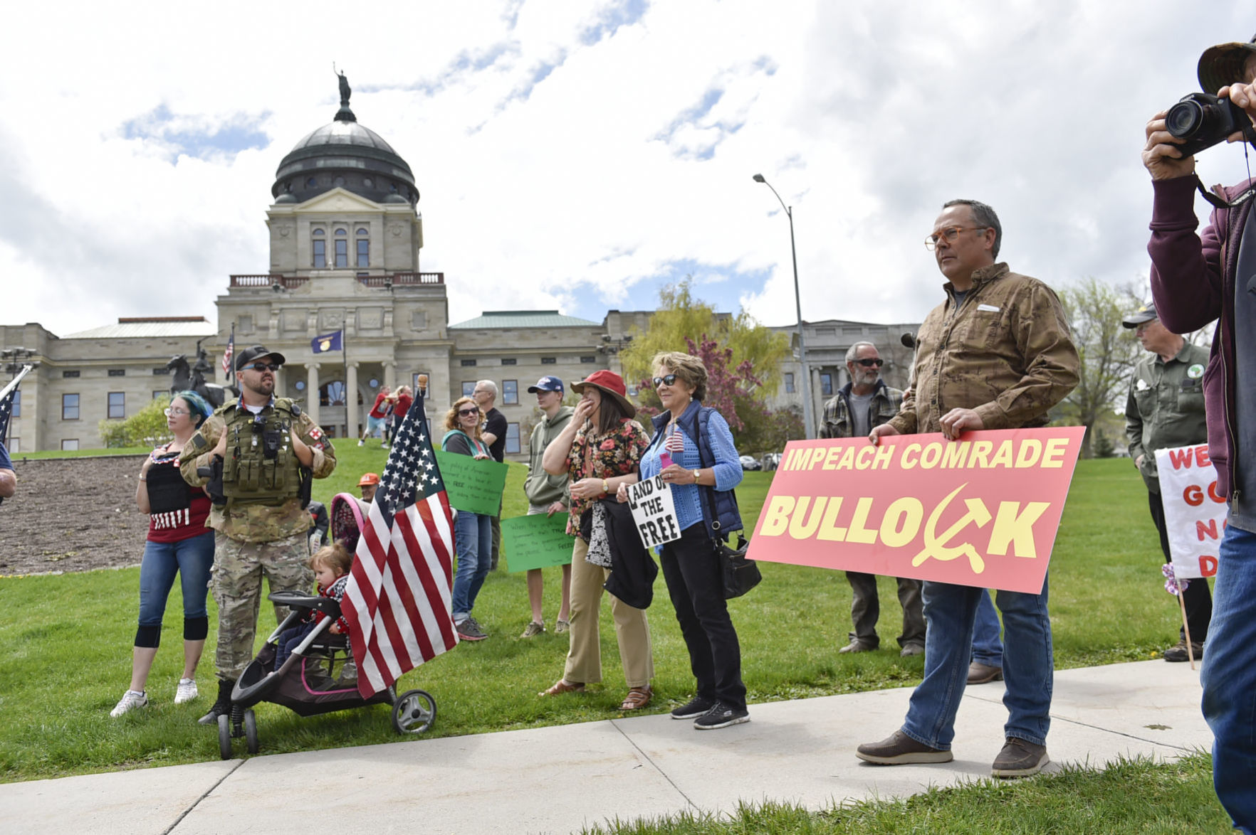 Protesters gather outside the Montana State Capitol Wednesday criticizing Gov. Steve Bullock's response to the COVID-19 pandemic.